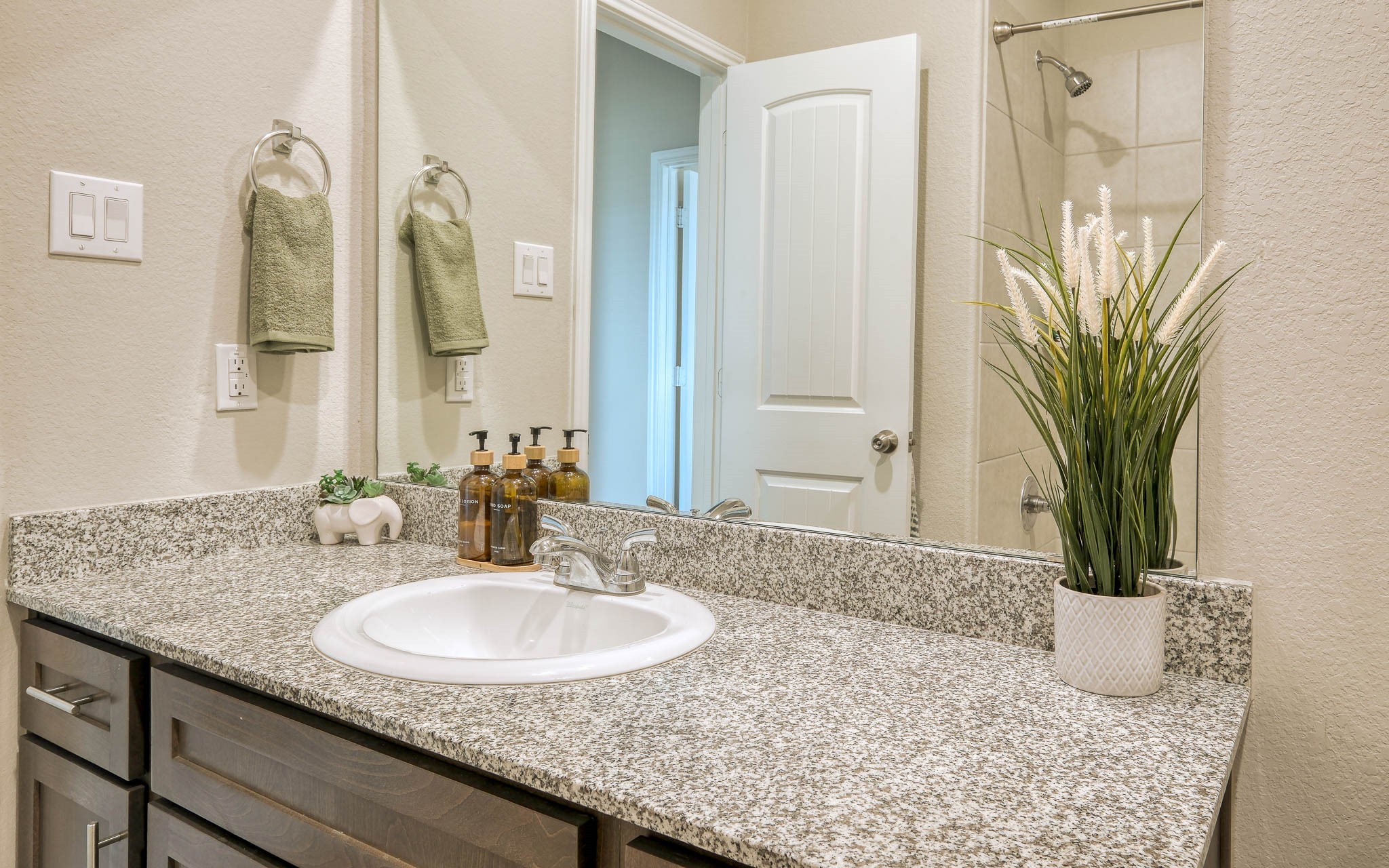 16747 Rockwall Street Conroe, TX 77303 - Photo 35 of 50 a bathroom with a granite countertop sink and a mirror