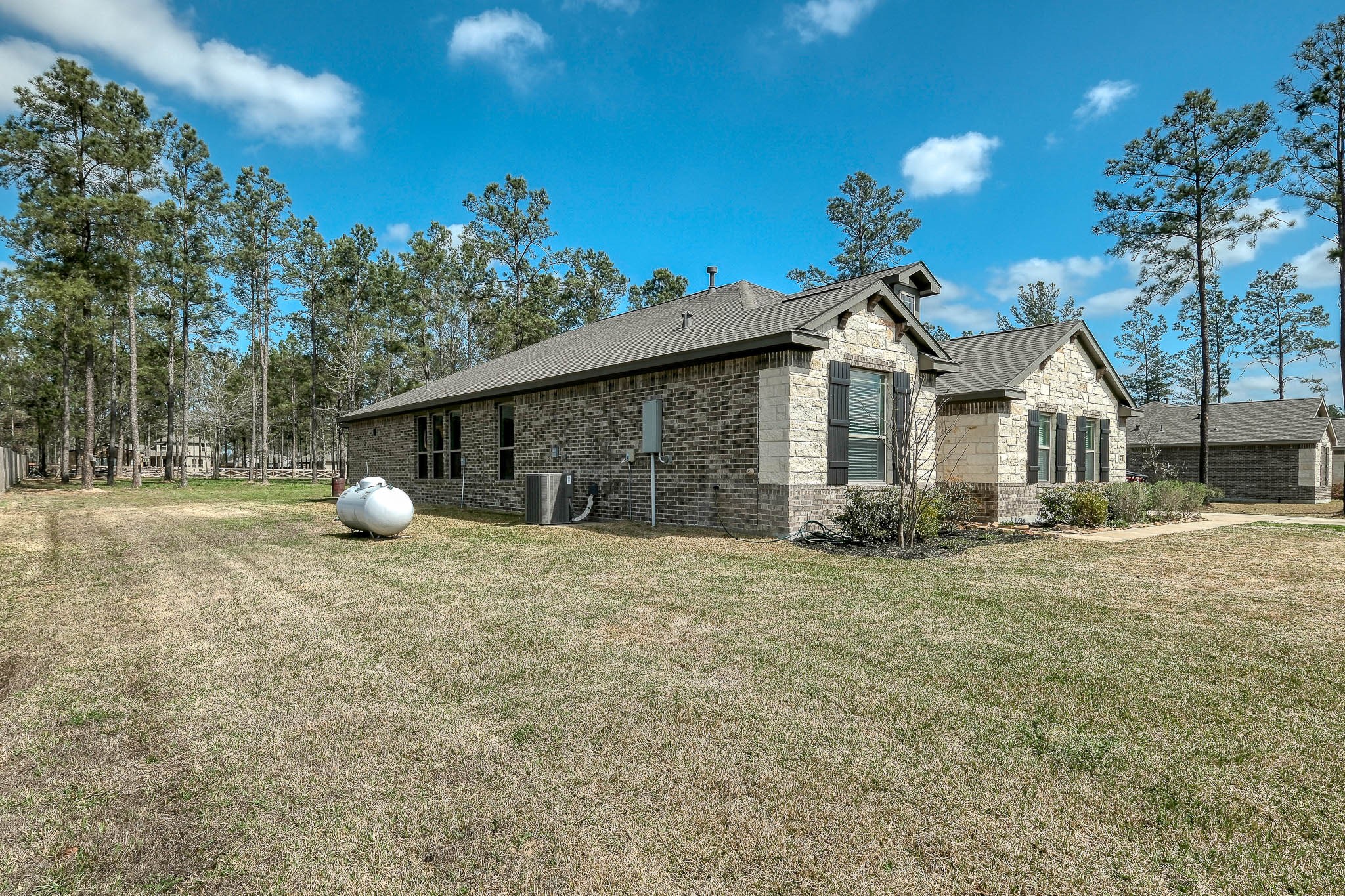 16747 Rockwall Street Conroe, TX 77303 - Photo 44 of 50 a front view of a house with a yard and tree s