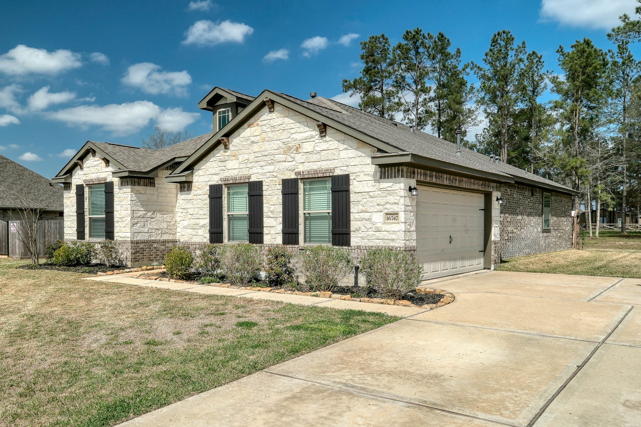 16747 Rockwall Street Conroe, TX 77303 - Photo 45 of 50 a front view of a house with a yard and potted plants