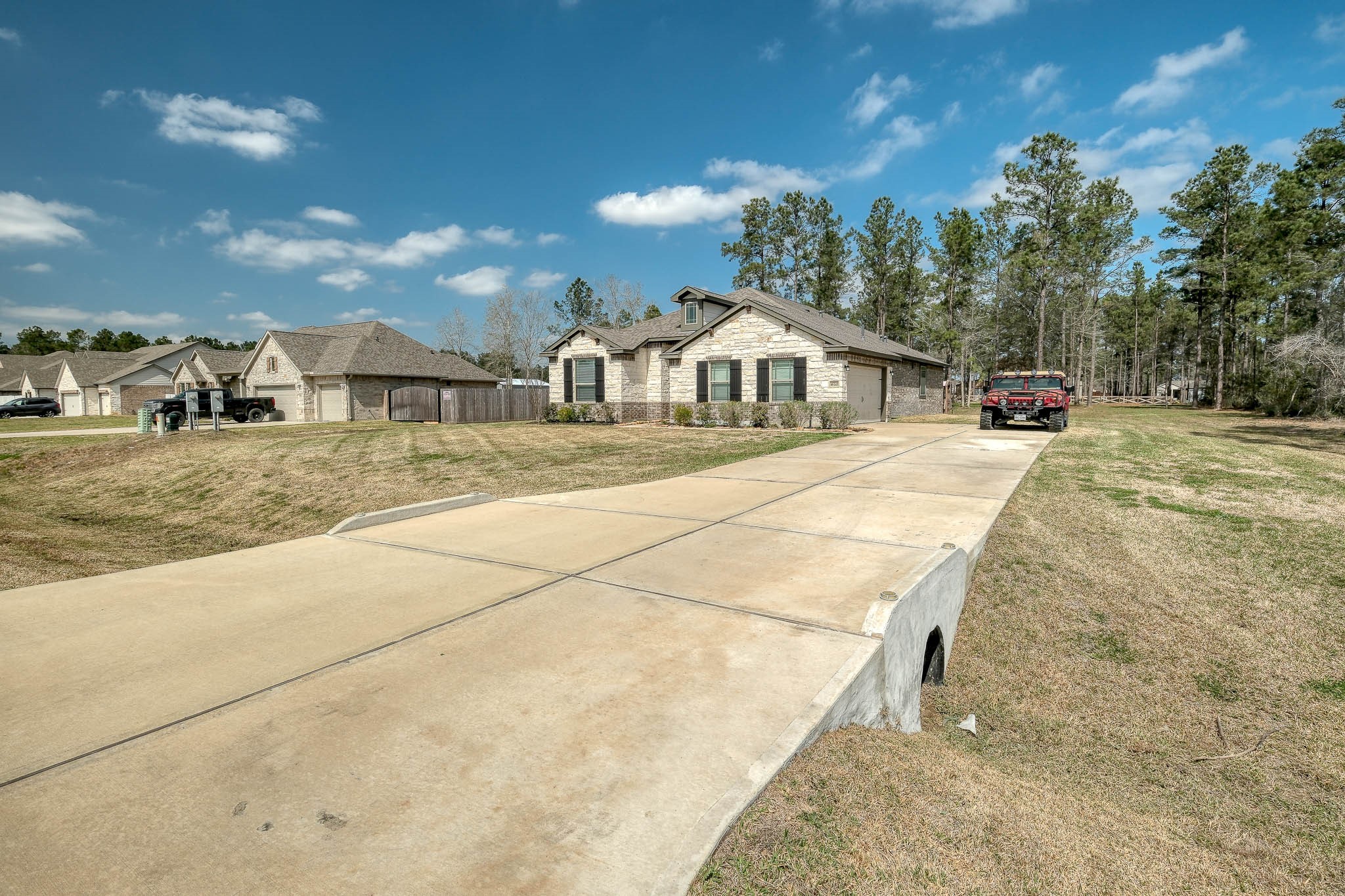 16747 Rockwall Street Conroe, TX 77303 - Photo 48 of 50 Lonnnnnnng driveway to your new home at 16747 Rockwall St, stone and brick home just built in 2023.