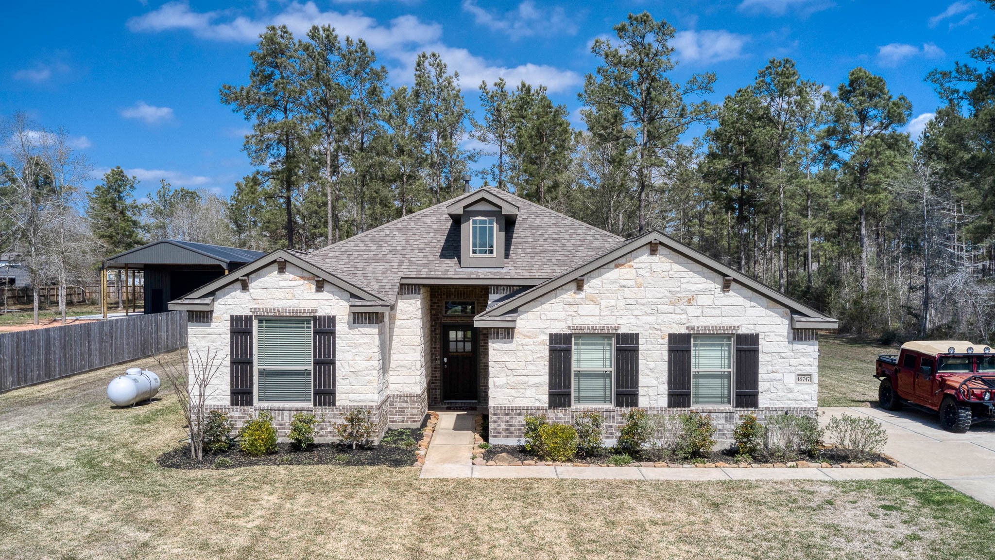 16747 Rockwall Street Conroe, TX 77303 - Photo 6 of 50 a front view of a house with a yard and potted plants