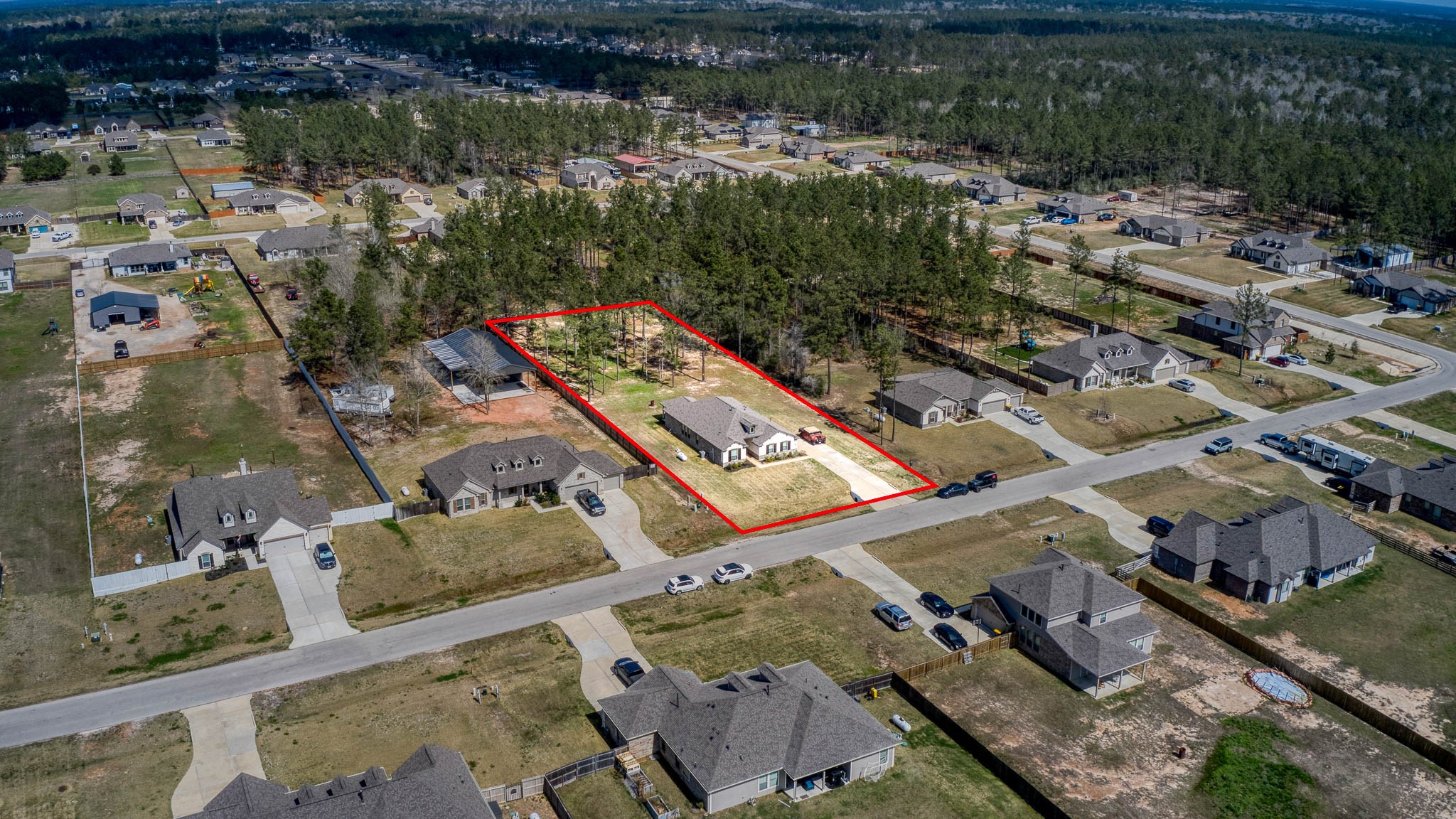 16747 Rockwall Street Conroe, TX 77303 - Photo 8 of 50 This acreage community is well-maintained by neighbors who share the country living dream. DIGITALLY STAGED to spark the imagination -- front to back, this entire .99 acre has so many possibilities and awaits your imagination. 16747 Rockwall St, 77303 features .9 partially cleared acre, stone and brick home built in 2023. Well cared for, and ready to grow your dreams!