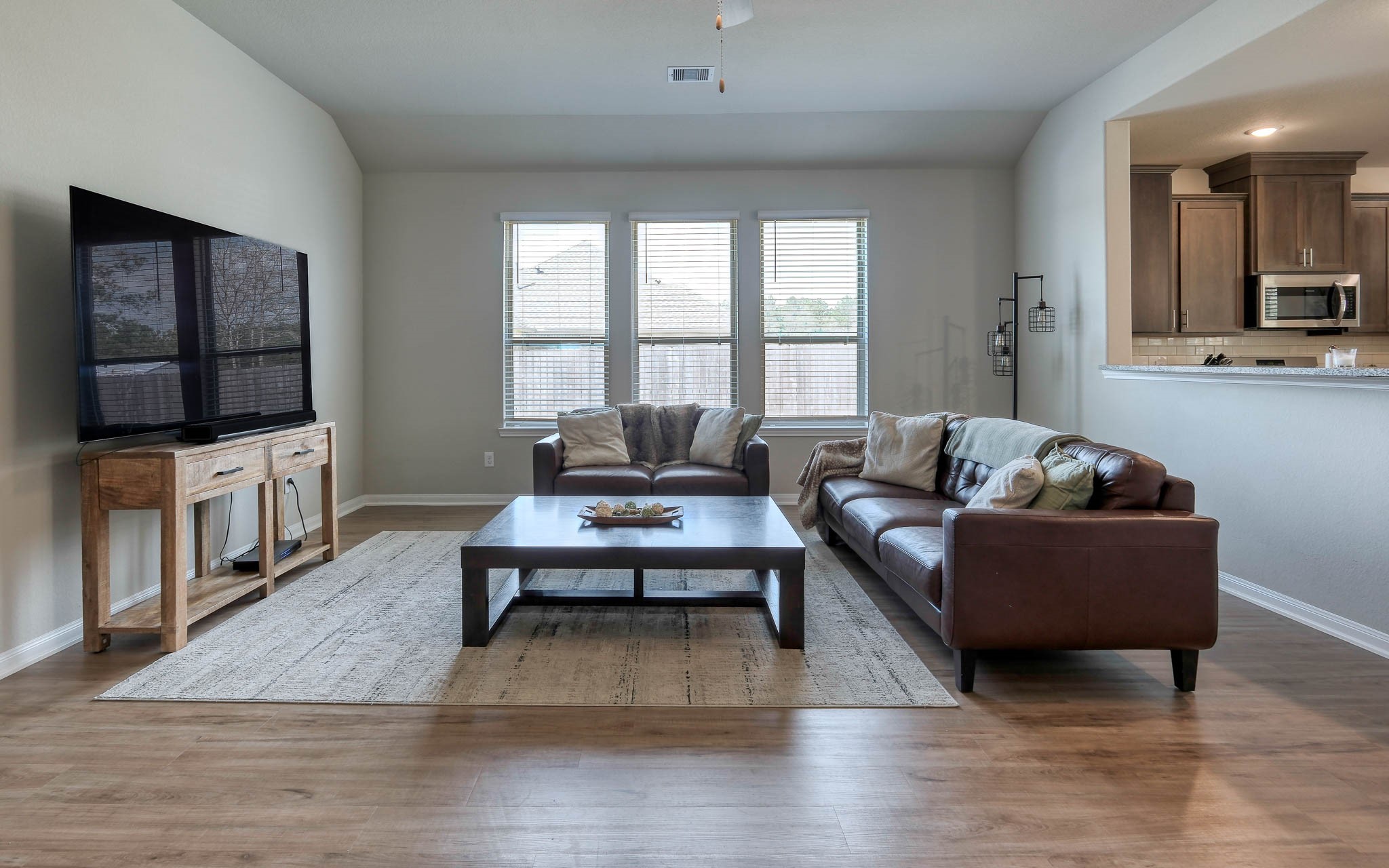 16747 Rockwall Street Conroe, TX 77303 - Photo 9 of 50 a living room with furniture wooden floor and a flat screen tv