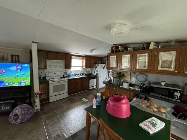 a kitchen with a refrigerator and a stove