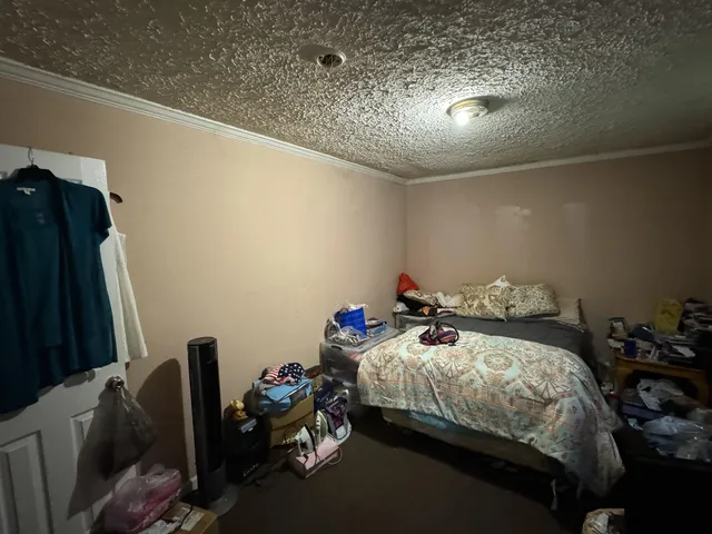 a bedroom with bed and a chandelier