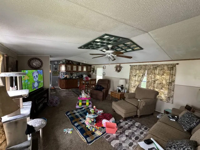 a living room with furniture and a chandelier