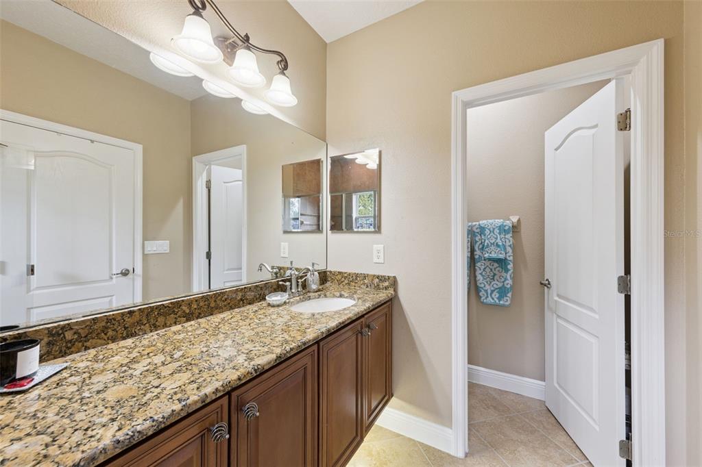 607 Pensacola Lane Lake Mary, FL 32746 - Photo 14 of 35 a bathroom with a granite countertop sink and a mirror