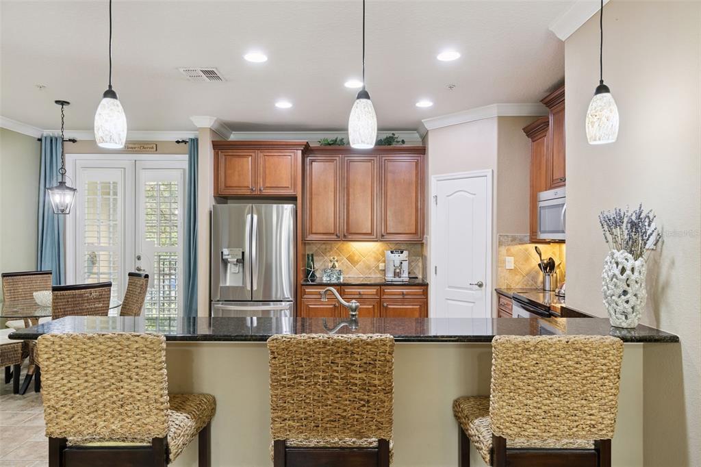 607 Pensacola Lane Lake Mary, FL 32746 - Photo 5 of 35 a open kitchen with stainless steel appliances granite countertop a stove refrigerator and chandelier