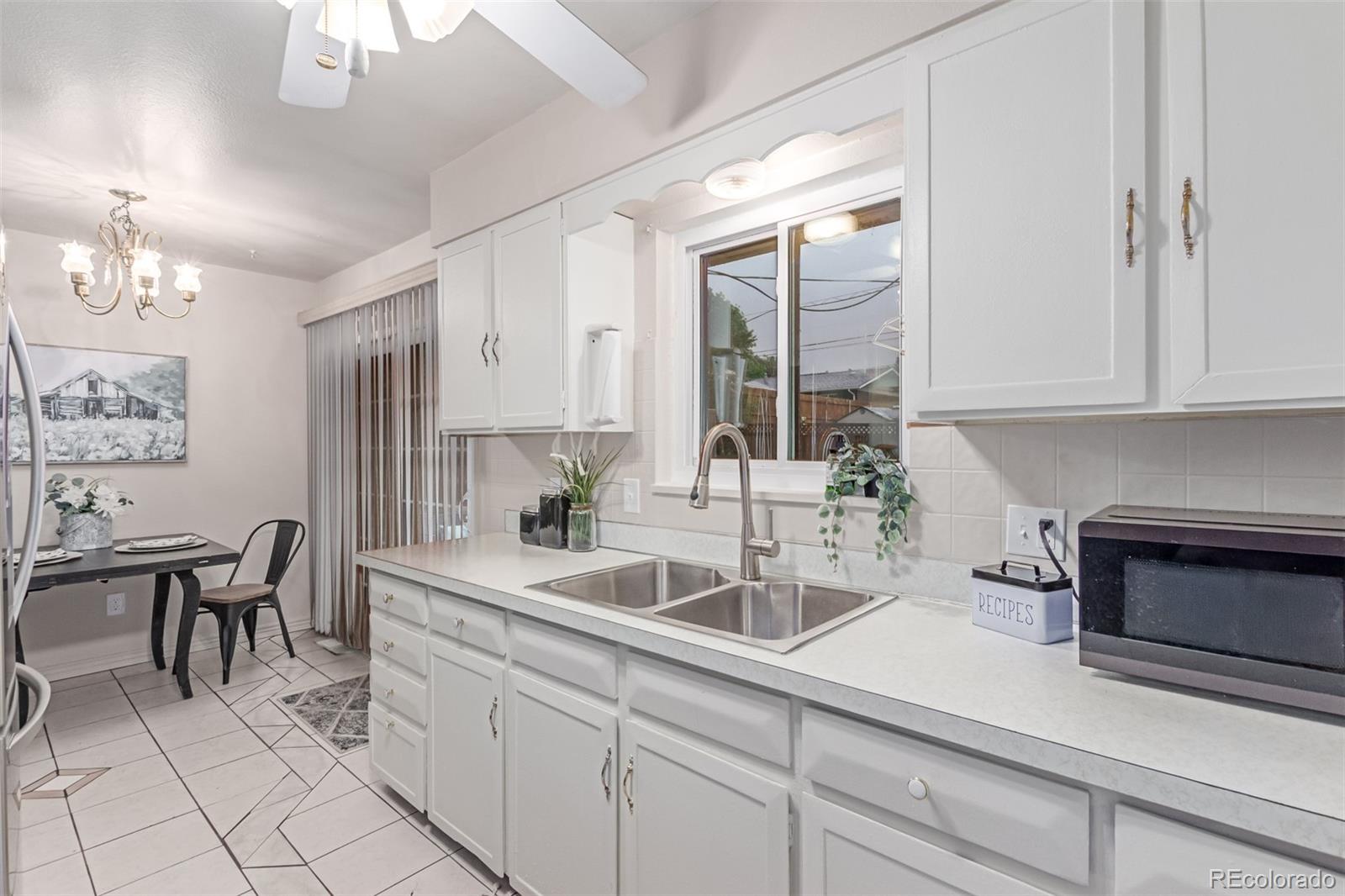 1285 Elder Street Denver, CO 80221 - Photo 11 of 35 a kitchen with a sink cabinets and window