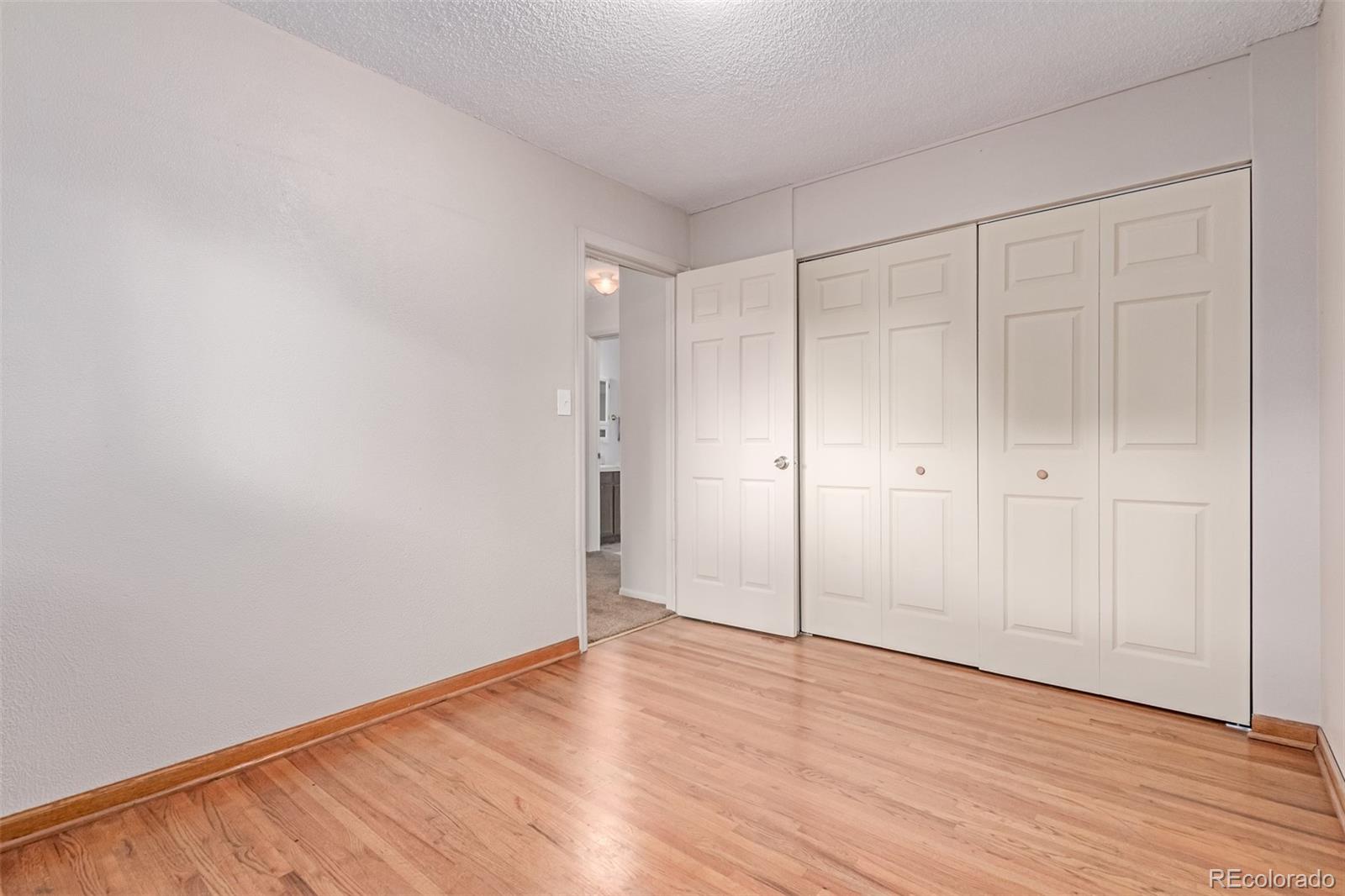 1285 Elder Street Denver, CO 80221 - Photo 19 of 35 a view of an empty room with wooden floor
