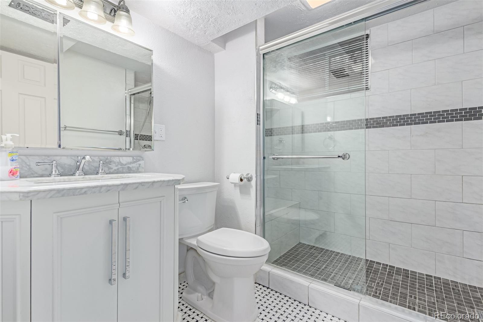 1285 Elder Street Denver, CO 80221 - Photo 22 of 35 a bathroom with a toilet sink and a shower