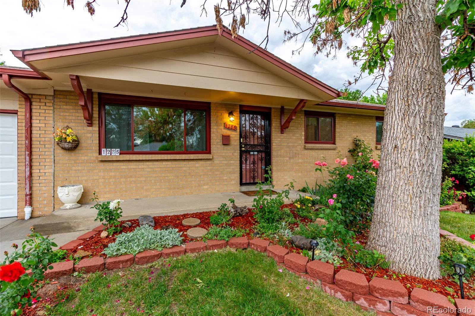 1285 Elder Street Denver, CO 80221 - Photo 3 of 35 a front view of a house with a yard