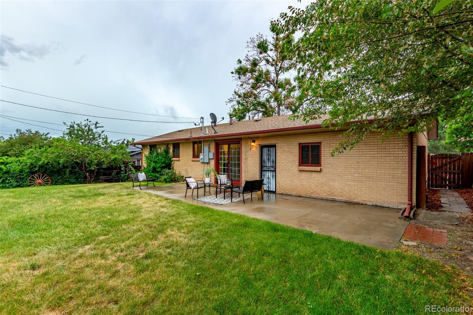 1285 Elder Street Denver, CO 80221 - Photo 31 of 35 a view of a house with backyard sitting area and garden