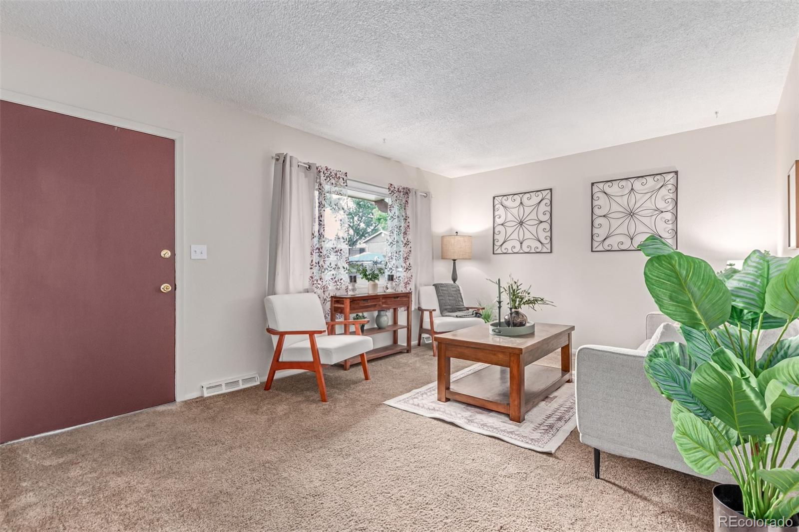 1285 Elder Street Denver, CO 80221 - Photo 5 of 35 a living room with furniture and a potted plant