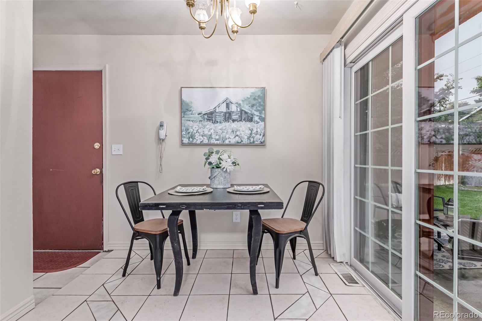 1285 Elder Street Denver, CO 80221 - Photo 9 of 35 a view of a dining room with furniture and chandelier