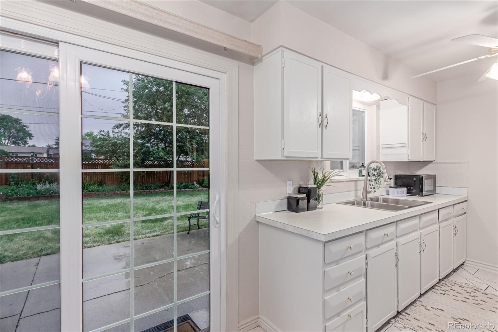 1285 Elder Street Denver, CO 80221 - Photo 10 of 35 a kitchen with a sink window cabinets and appliances