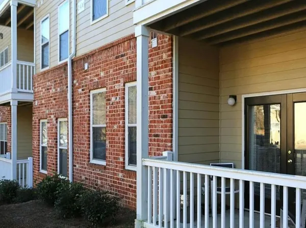 a view of a brick house with a large window