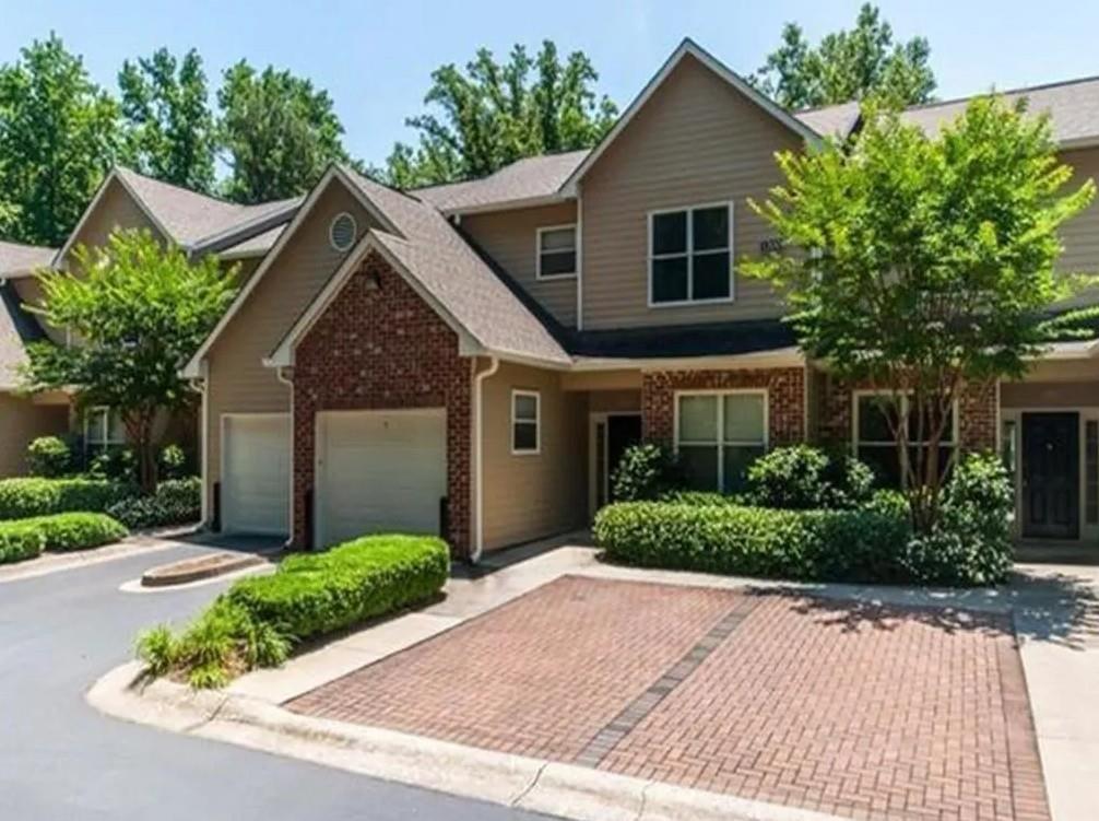 1600 Blairs Bridge Road, Unit 2302 Lithia Springs, GA 30122 - Photo 19 of 21 a front view of a house with a yard and potted plants