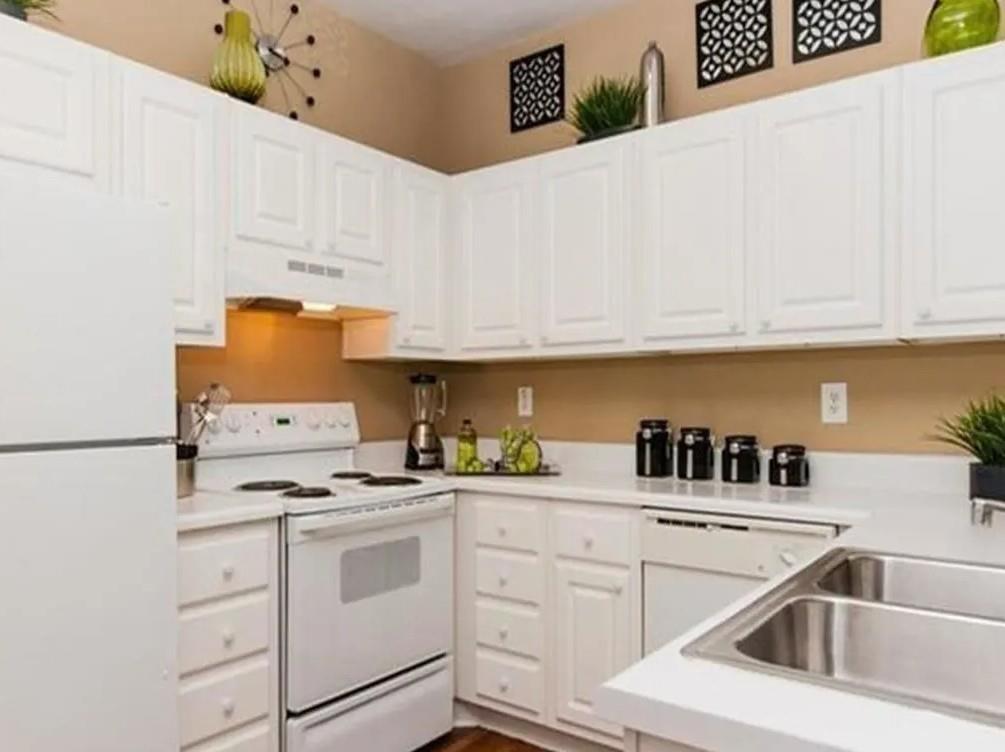 1600 Blairs Bridge Road, Unit 2302 Lithia Springs, GA 30122 - Photo 4 of 21 a kitchen with white cabinets and white appliances