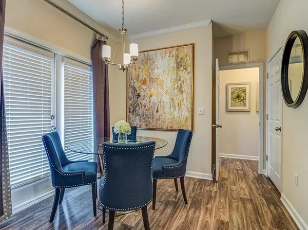 a view of a dining room with furniture window and wooden floor
