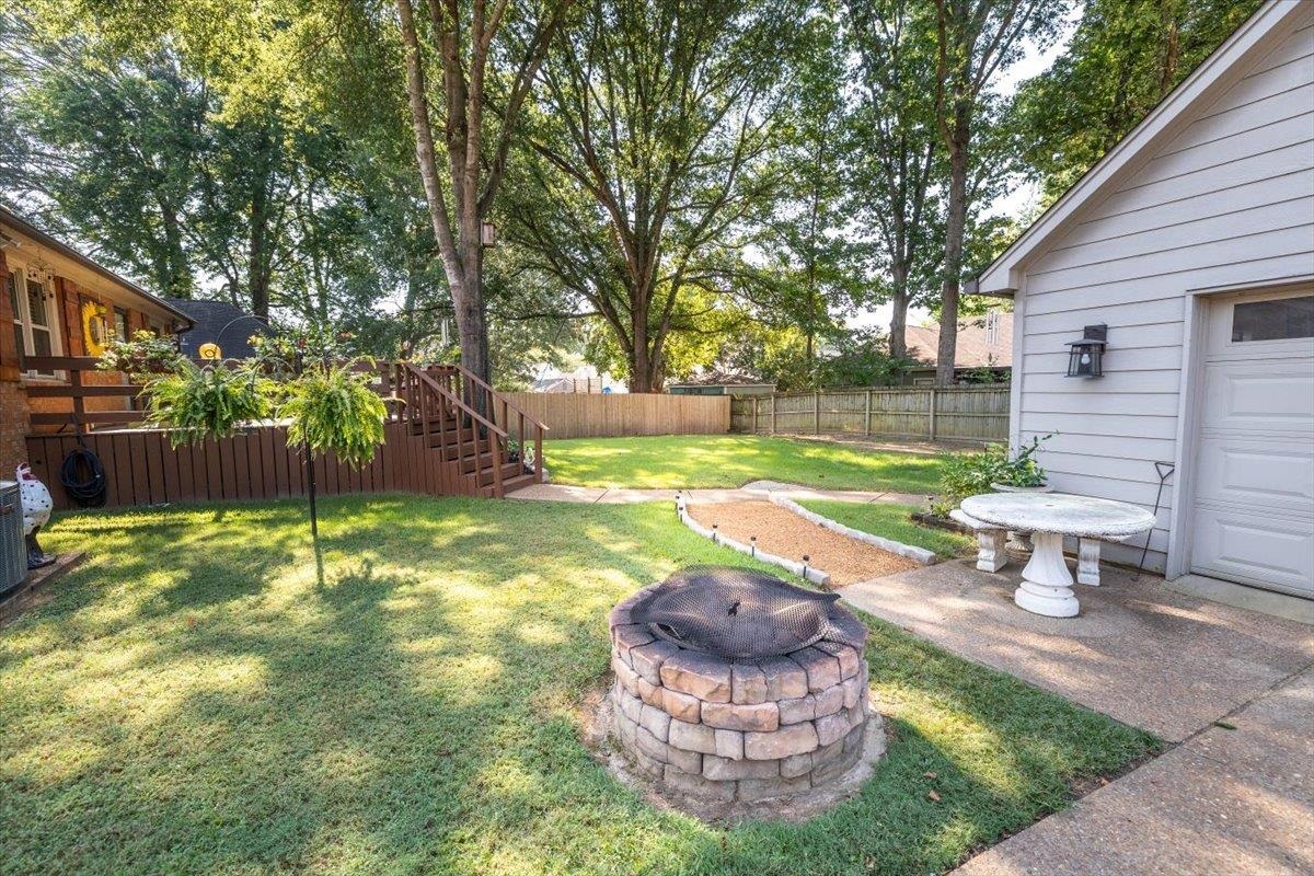 8523 Bazemore Road Memphis, TN 38018 - Photo 35 of 40 a view of a backyard with table and chairs and a fire pit