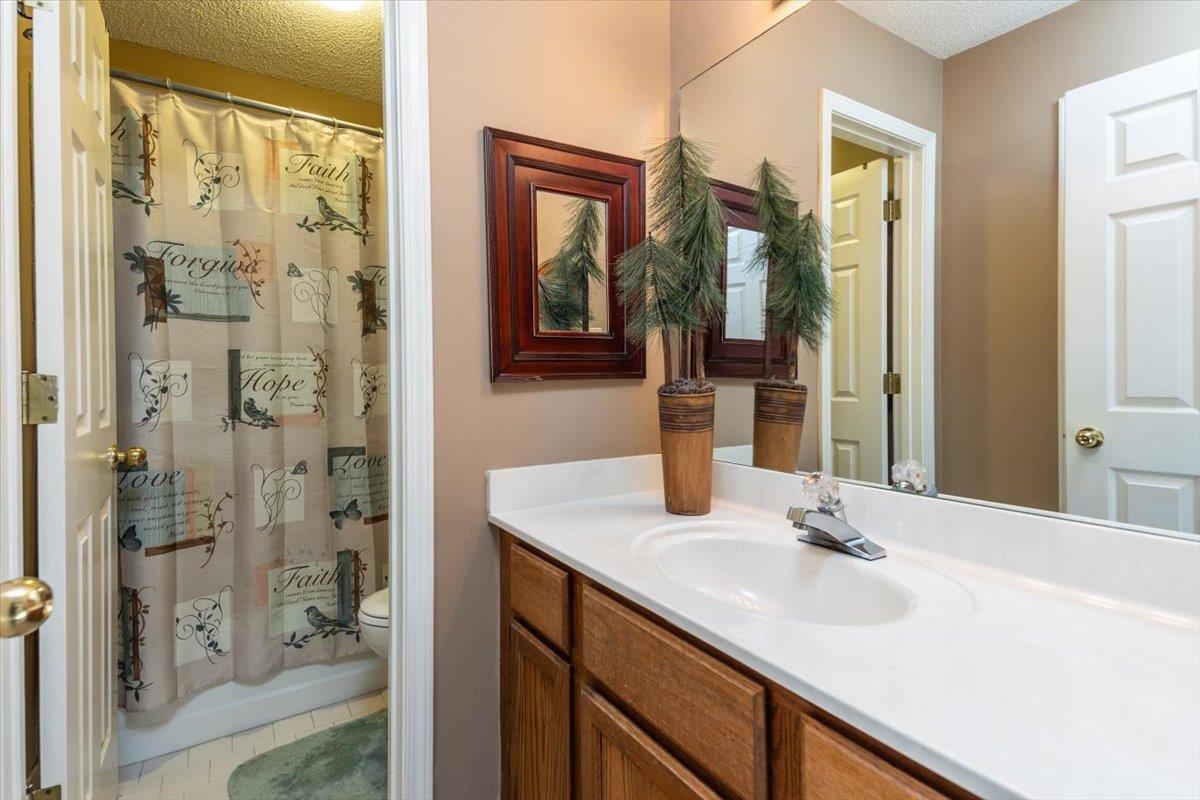 8523 Bazemore Road Memphis, TN 38018 - Photo 9 of 40 a bathroom with a sink vanity granite shower and a mirror