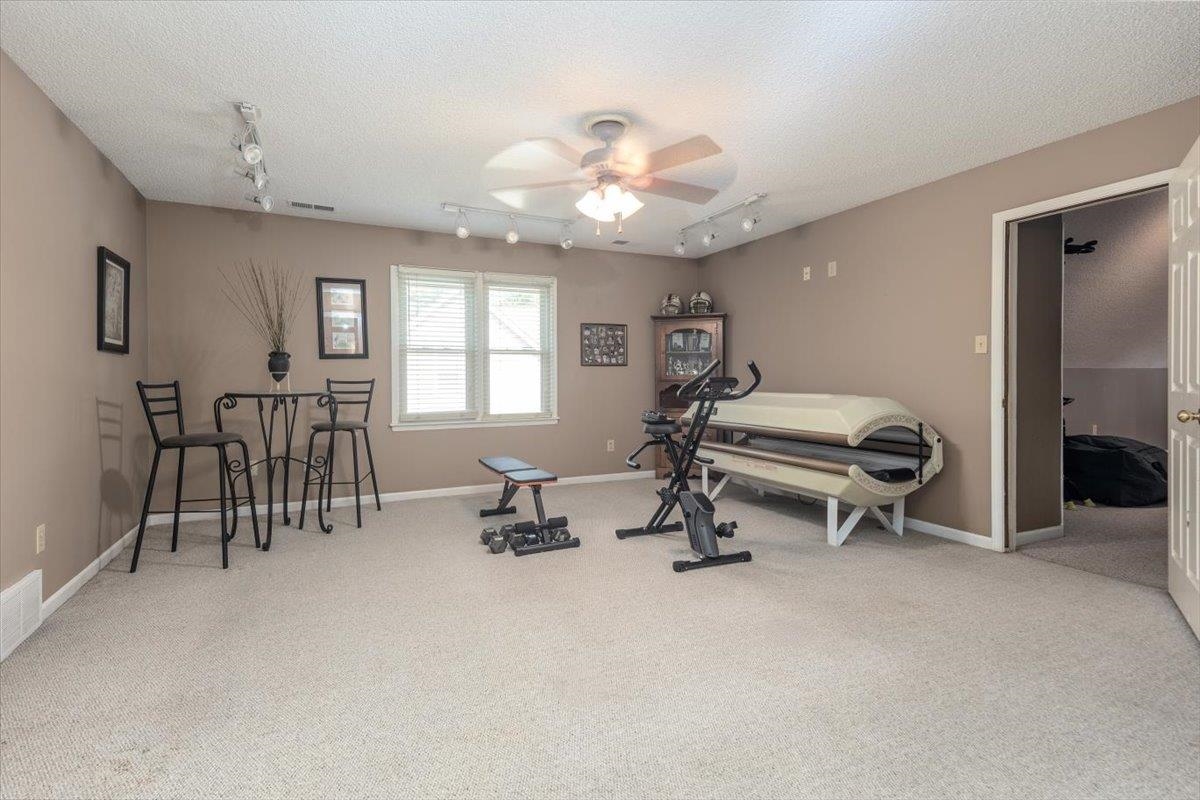 8523 Bazemore Road Memphis, TN 38018 - Photo 10 of 40 a room with gym equipment and a chandelier