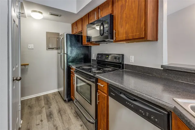 a kitchen with stainless steel appliances a refrigerator a stove and cabinets
