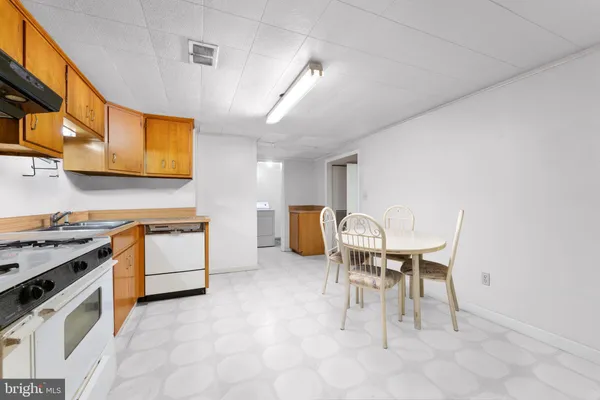 a kitchen with a table chairs and a stove