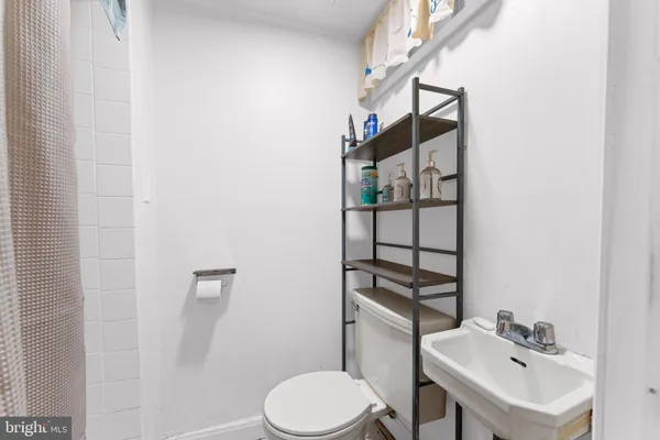 a bathroom with a sink toilet and mirror