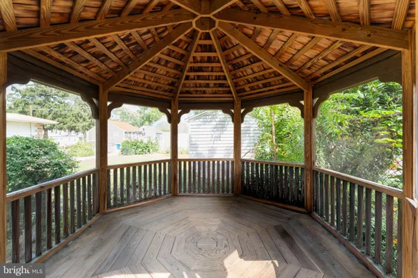 a view of porch with wooden floor in front of a house