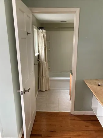 a bathroom with a granite countertop sink and a shower curtain
