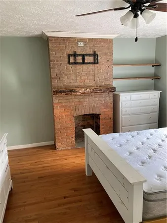 a room with a bed and wooden floor