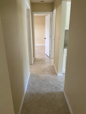 a kitchen with cabinets and a refrigerator