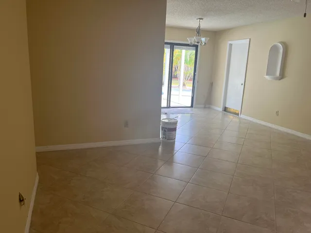 a view of a room with wooden floor and a window
