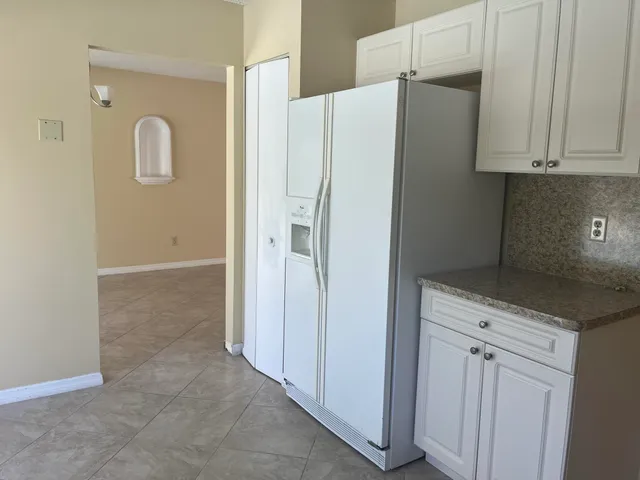 a kitchen with granite countertop a sink stove and refrigerator