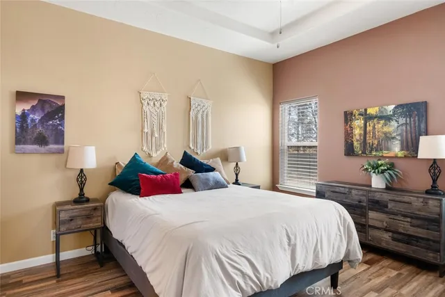a bedroom with bed and wooden floor