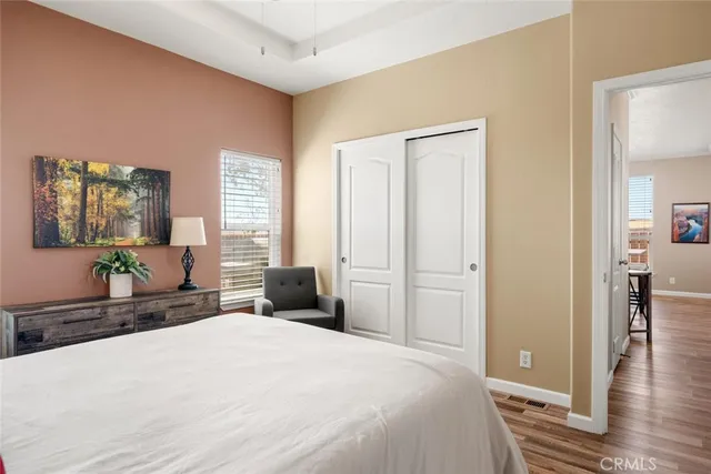 a bedroom with a bed and wooden floor