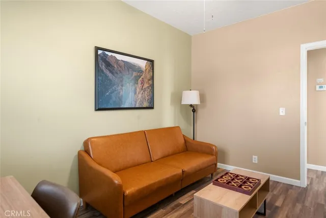 a blue couch sitting next to a blue wall and a lamp