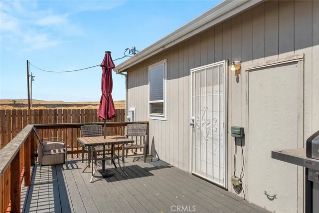 a view of a balcony and chairs with wooden floor