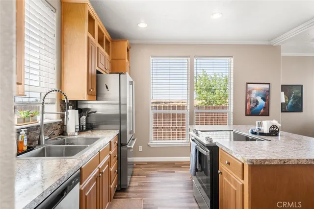a kitchen with granite countertop a sink and a stove