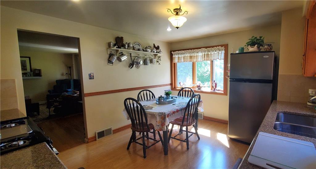 4355 Ellwood Road New Castle, PA 16101 - Photo 8 of 25 a dining room with furniture a window and wooden floor