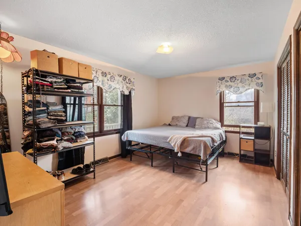 a bedroom with a large bed and a flat screen tv
