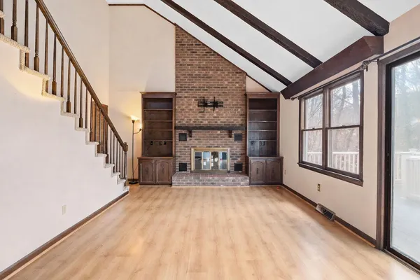 a living room with furniture a fireplace and a large window