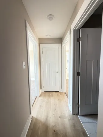 a view of hallway with wooden floor