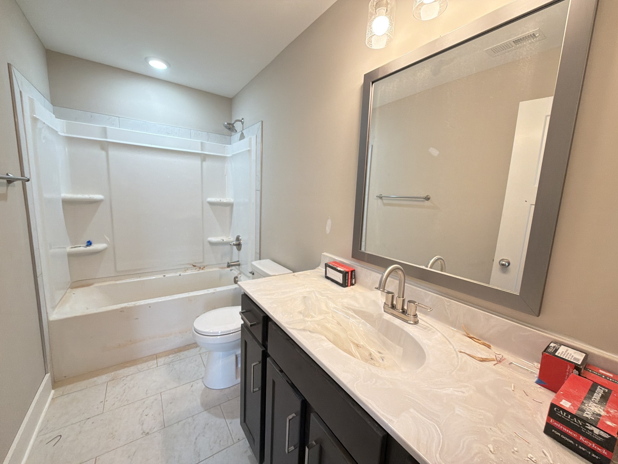 630 Avondale Road Oak Grove, KY 42262 - Photo 17 of 23 a bathroom with a granite countertop sink a toilet a mirror a bathtub and shower