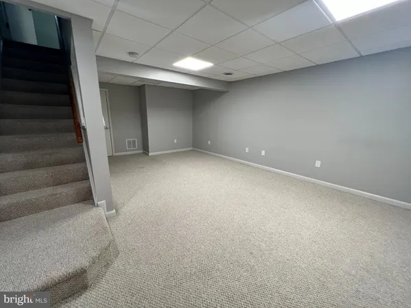a view of an empty room with stairs