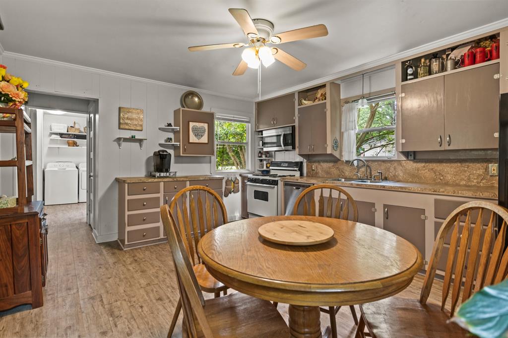 103 South Sun Camp Road White Oak, TX 75693 - Photo 15 of 40 a kitchen with furniture and a chandelier