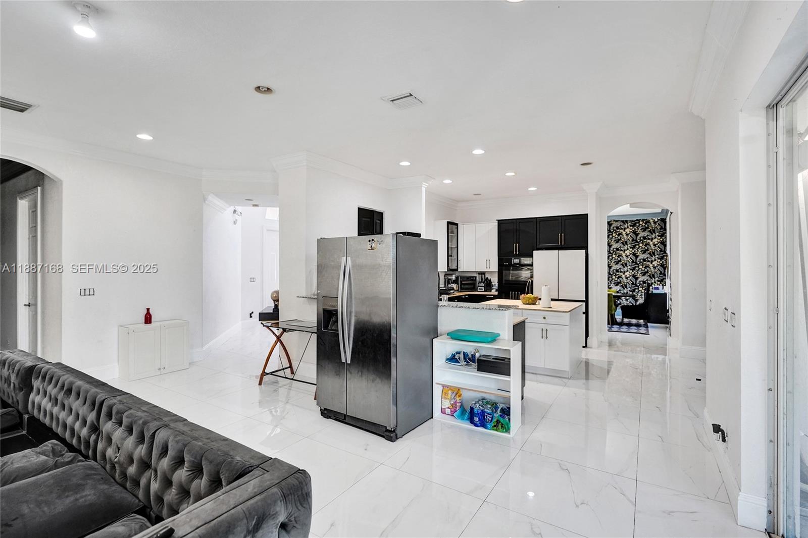 8824 Cobblestone Point Circle Boynton Beach, FL 33472 - Photo 12 of 53 a kitchen with stainless steel appliances kitchen island granite countertop a refrigerator and a cabinets