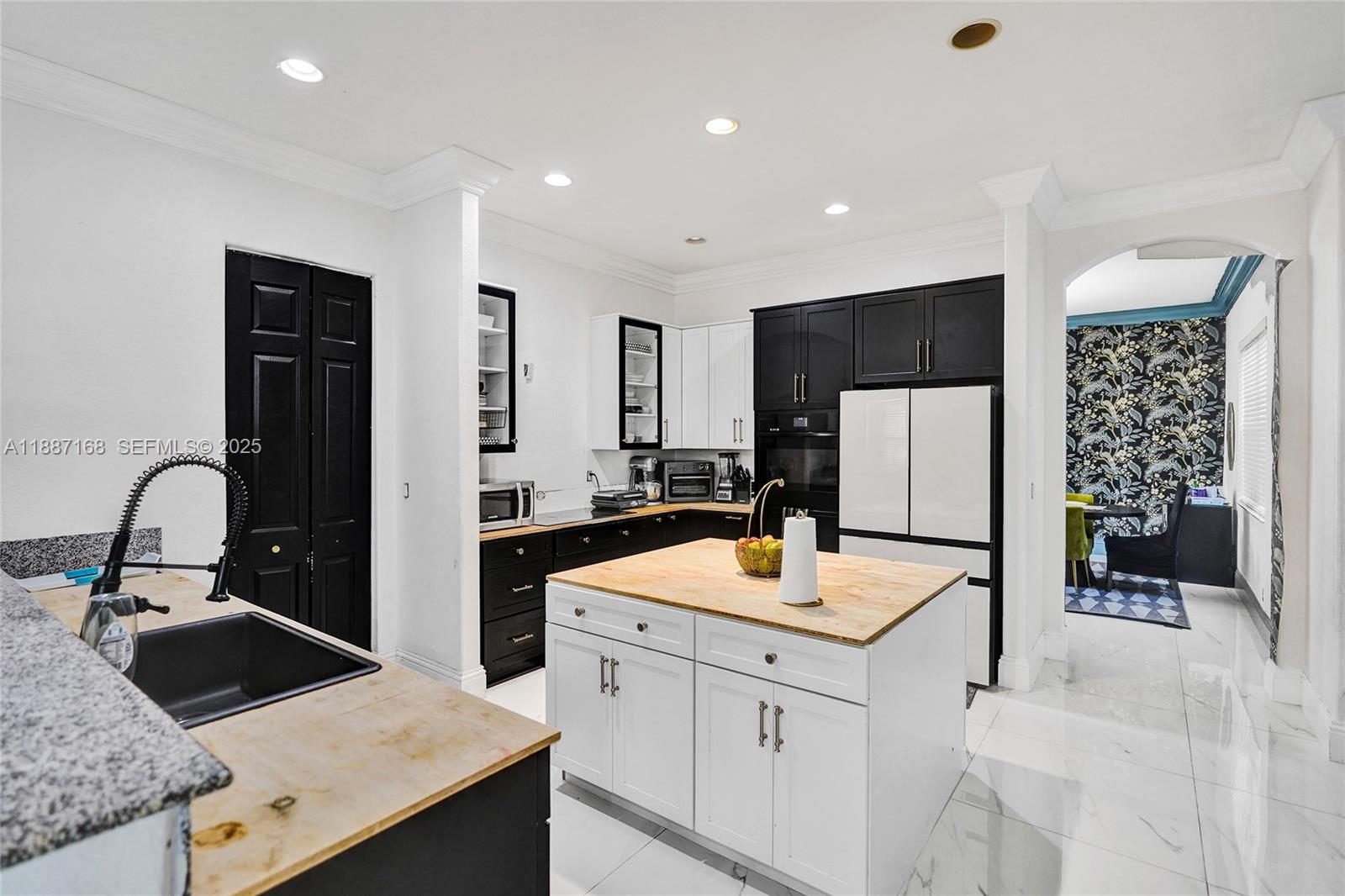 8824 Cobblestone Point Circle Boynton Beach, FL 33472 - Photo 13 of 53 a kitchen with granite countertop a sink stainless steel appliances and refrigerator